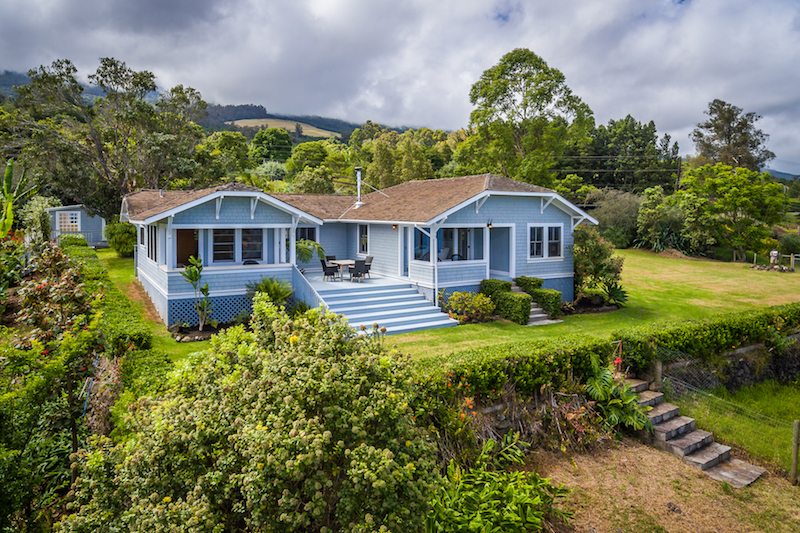 An aerial shot showing the back of the Hawaii Plantation Style Home in Kula including the covered and uncovered lanai spaces