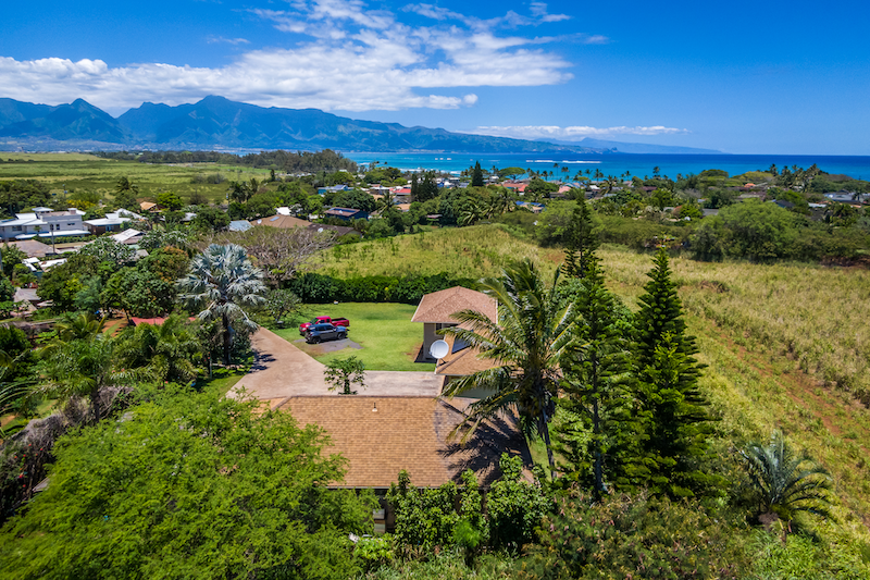 Aerial View of the 118 and 120 Ulumau. This shot looks towards Paia town and the ocean with the West Maui Mountains in the distance. 