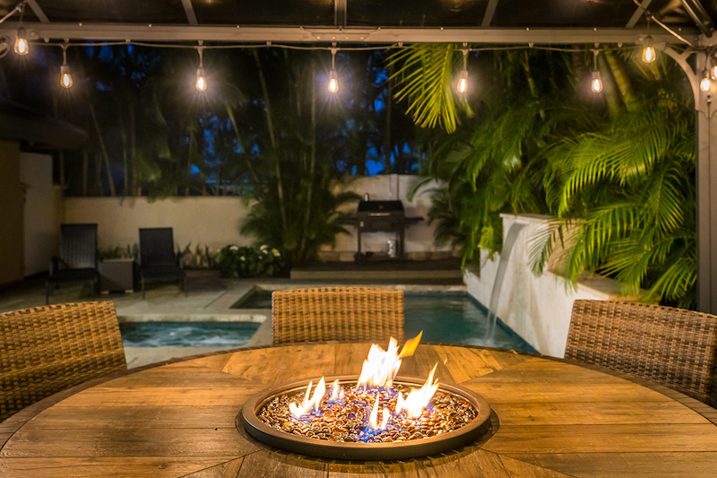 A fire pit by the pool area of a home in the Island at Maui Lani