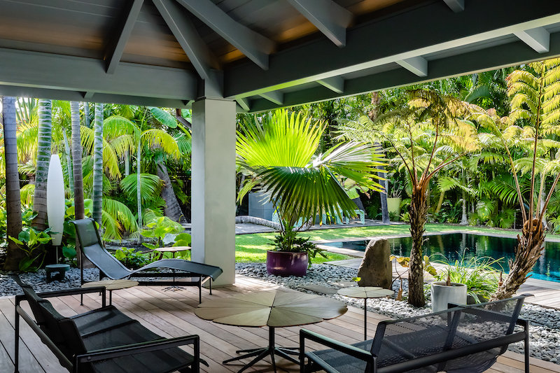 a covered lanai space that overlooks the pool