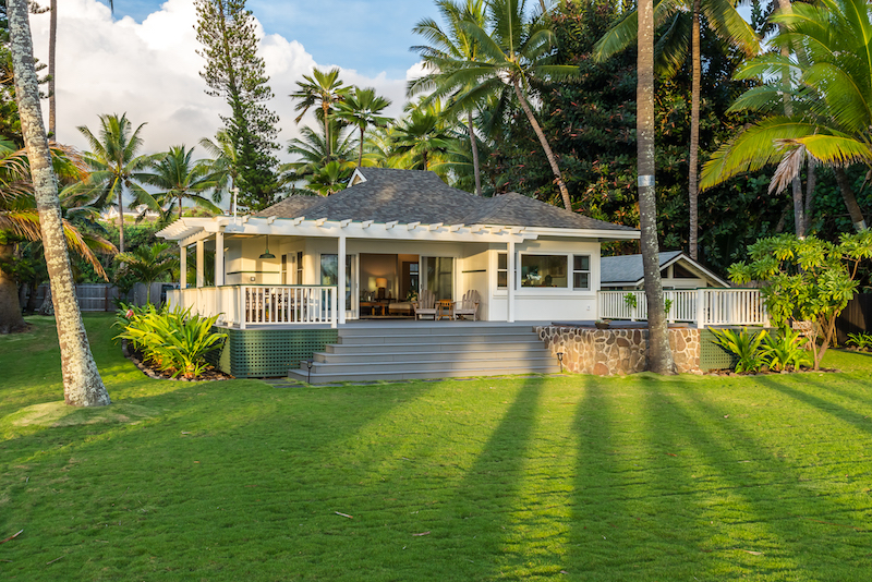 Early morning light on the exterior of this cottage by the sea in Wailuku